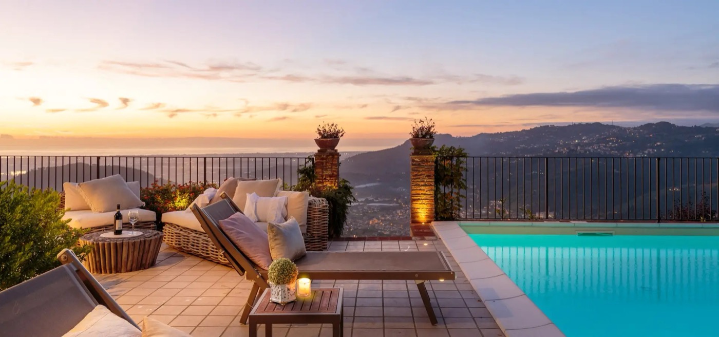 Lucca Apartments & Villas — sunset pool terrace over the Tuscan hills