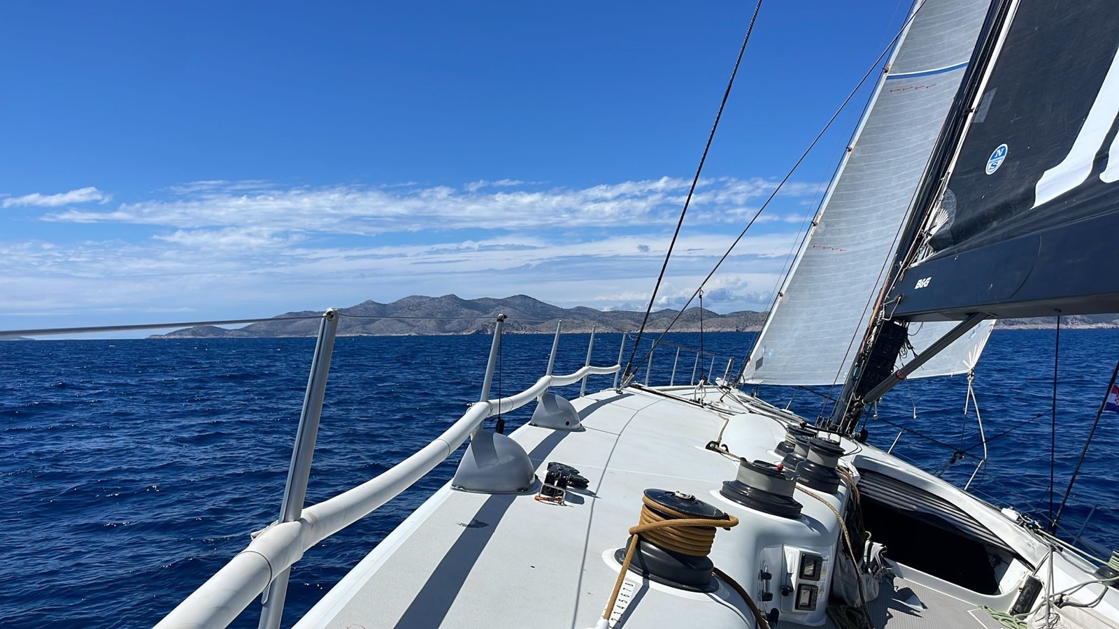 Vertical Sailing Tour — sailing toward an island across the Mediterranean